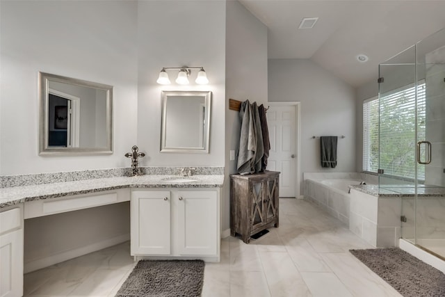bathroom with marble look tiles, a shower stall, a bath, vaulted ceiling, and vanity