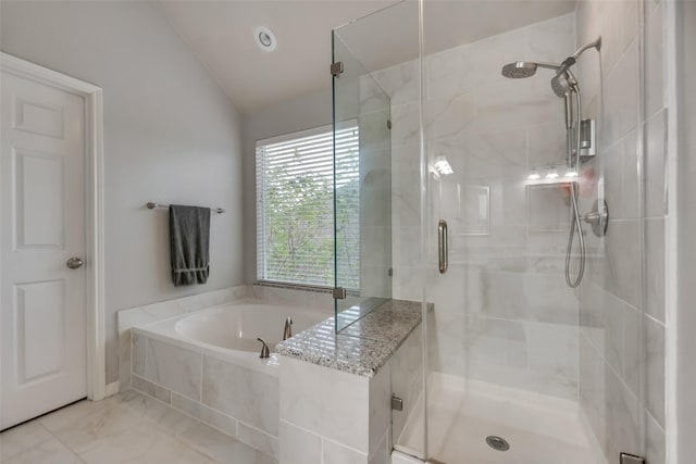 full bathroom featuring a bath, lofted ceiling, and a shower stall