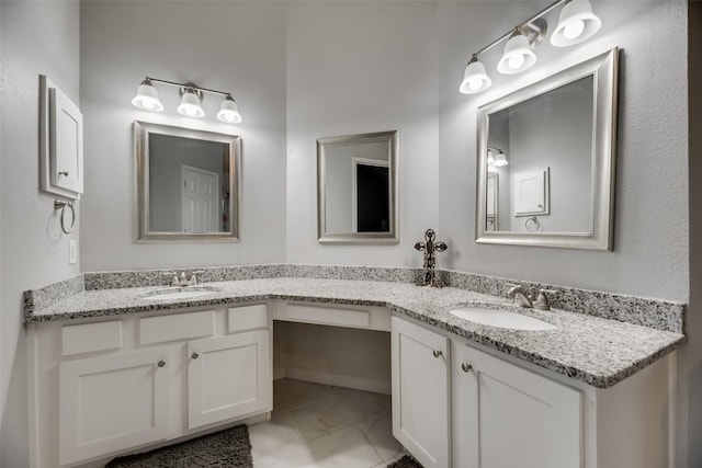 bathroom featuring marble finish flooring and double vanity