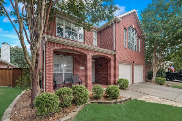 traditional home with brick siding, covered porch, and driveway