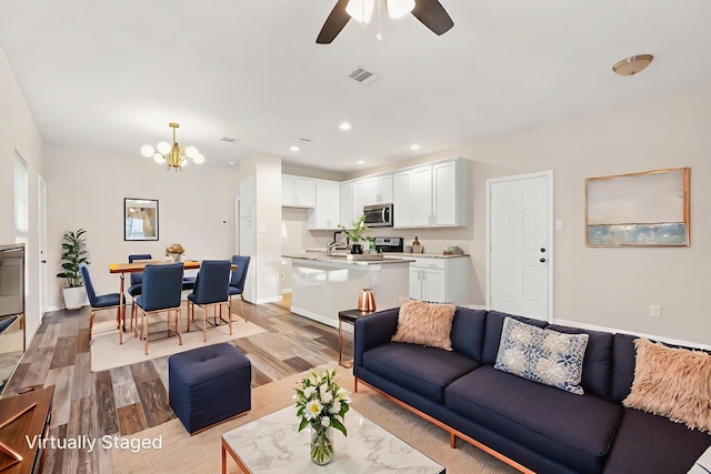 1504 Yale St, River Oaks, TX 76114 - living area featuring light wood finished floors, a chandelier, ceiling fan, and recessed lighting