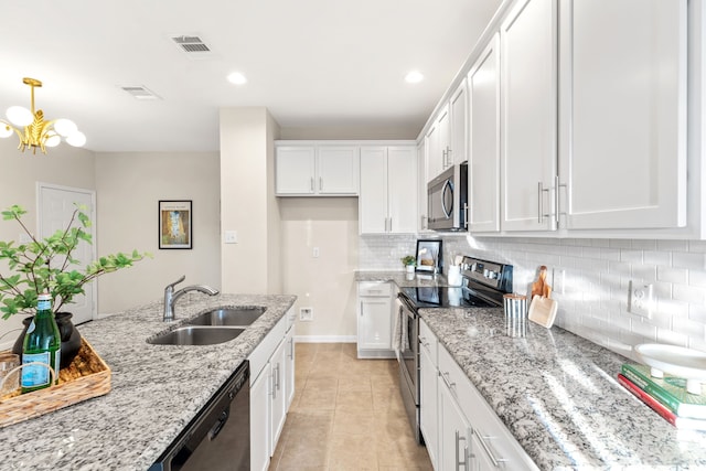 1504 Yale St, River Oaks, TX 76114 - kitchen featuring appliances with stainless steel finishes, white cabinets, backsplash, light tile patterned floors, and light stone countertops
