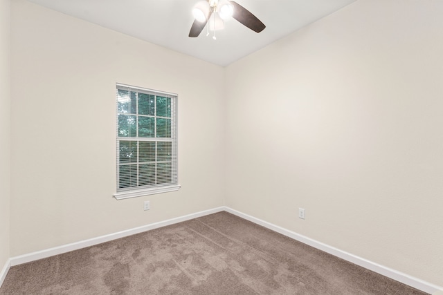 spare room featuring ceiling fan, carpet flooring, and baseboards