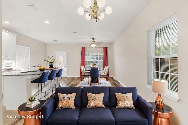 1504 Yale St, River Oaks, TX 76114 - living area with healthy amount of natural light, wood finished floors, a chandelier, a ceiling fan, and recessed lighting