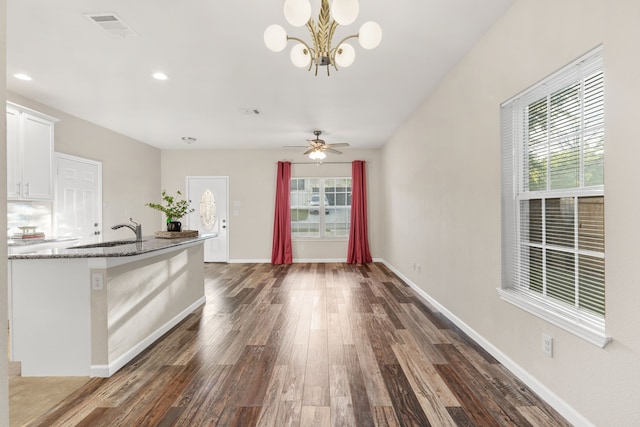 1504 Yale St, River Oaks, TX 76114 - kitchen with dark wood-style flooring, stone countertops, white cabinets, recessed lighting, and a chandelier