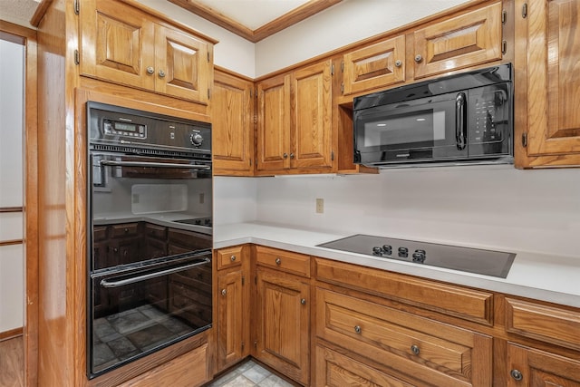 619 Wellington, Tyler, TX 75703 - kitchen featuring black appliances, light countertops, brown cabinetry, and crown molding