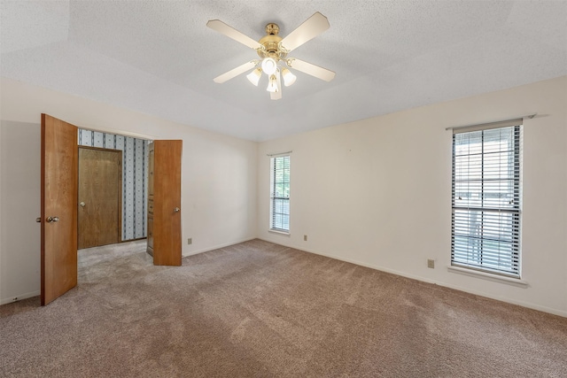 619 Wellington, Tyler, TX 75703 - unfurnished room featuring light carpet, ceiling fan, a textured ceiling, and baseboards