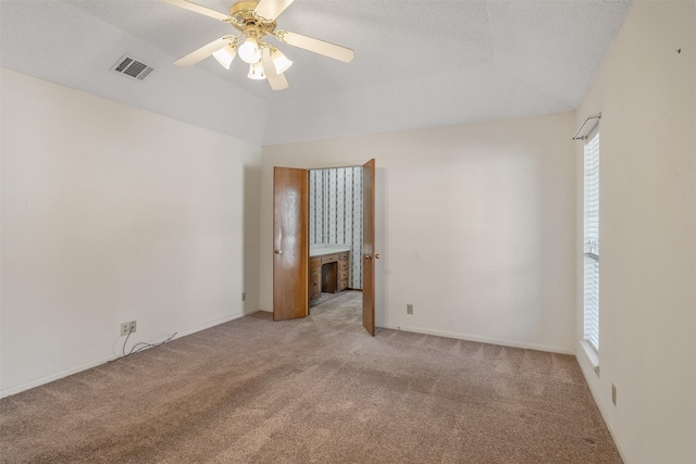 619 Wellington, Tyler, TX 75703 - spare room featuring light colored carpet, ceiling fan, vaulted ceiling, and baseboards