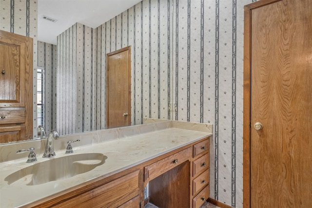 619 Wellington, Tyler, TX 75703 - bathroom featuring wallpapered walls and vanity