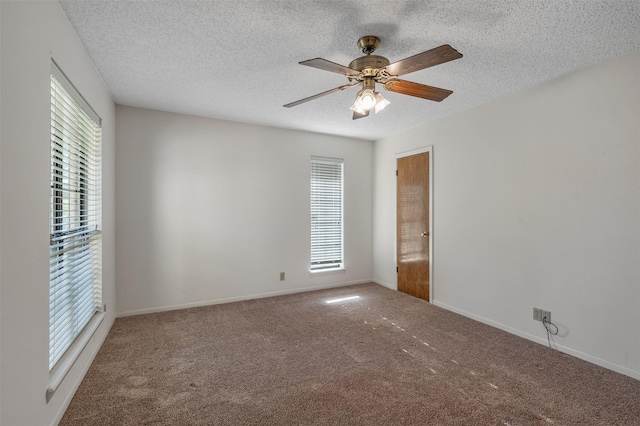 619 Wellington, Tyler, TX 75703 - carpeted spare room featuring plenty of natural light, a textured ceiling, ceiling fan, and baseboards