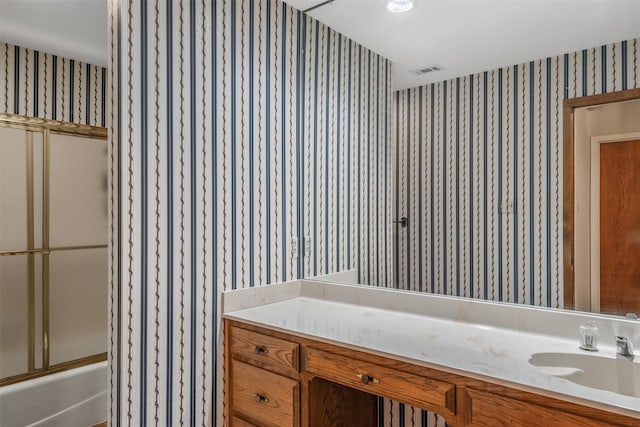619 Wellington, Tyler, TX 75703 - bathroom with wallpapered walls, vanity, and enclosed tub / shower combo