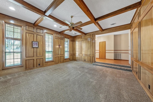 619 Wellington, Tyler, TX 75703 - carpeted empty room featuring a decorative wall, beamed ceiling, coffered ceiling, a textured ceiling, and a ceiling fan