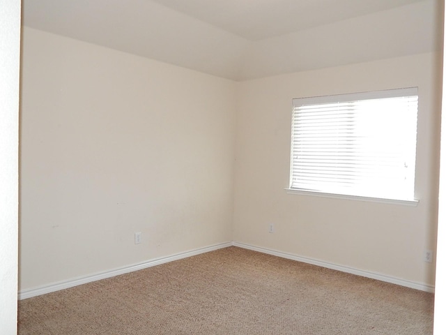 unfurnished room featuring carpet floors and baseboards