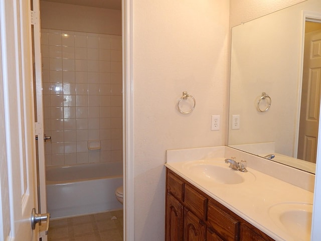 bathroom featuring double vanity and toilet
