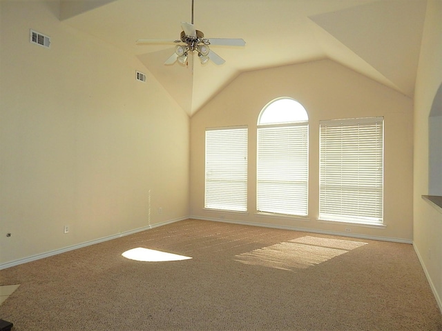 carpeted spare room featuring ceiling fan, lofted ceiling, and baseboards
