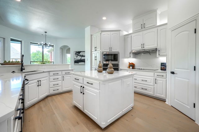 12809 Day Break Trl, Burleson, TX 76028 - kitchen with stainless steel appliances, a sink, arched walkways, under cabinet range hood, and recessed lighting