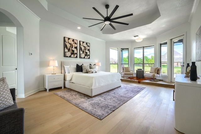12809 Day Break Trl, Burleson, TX 76028 - bedroom featuring multiple windows, light wood-style flooring, arched walkways, crown molding, and recessed lighting