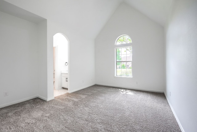 12809 Day Break Trl, Burleson, TX 76028 - carpeted spare room featuring arched walkways, baseboards, and high vaulted ceiling