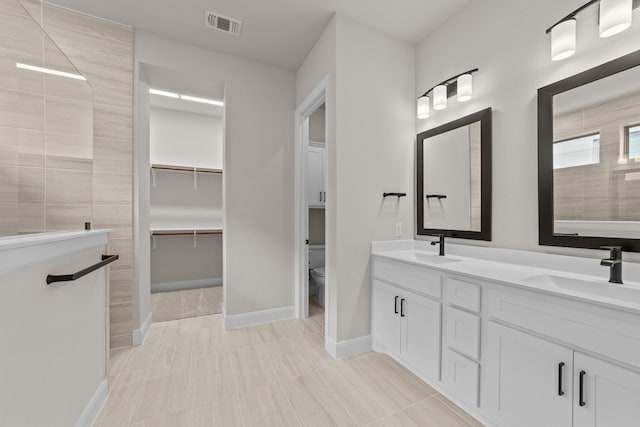 606 Lundy Ln, Mansfield, TX 76063 - full bath with double vanity, toilet, walk in shower, and baseboards