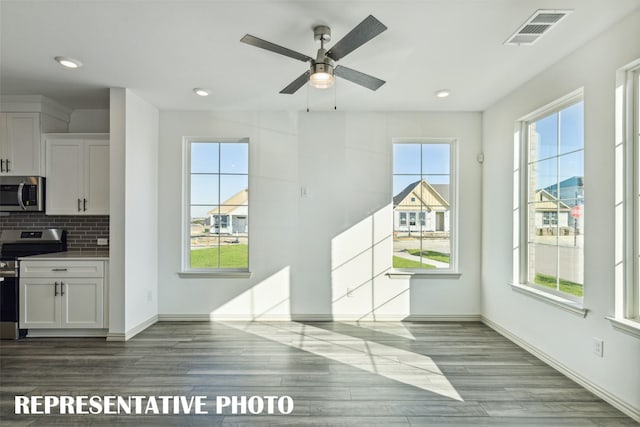 5236 Springlake Pkwy, Haltom City, TX 76117 - unfurnished dining area featuring wood finished floors, baseboards, a ceiling fan, and recessed lighting