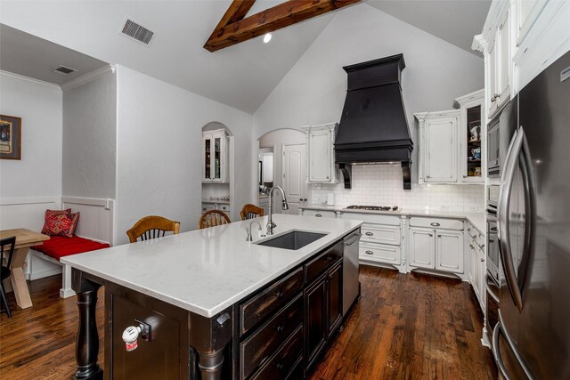 kitchen featuring stainless steel appliances, a sink, premium range hood, a kitchen breakfast bar, and dark wood-style flooring