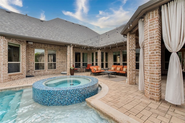view of swimming pool with an outdoor hangout area, a patio area, and a pool with connected hot tub