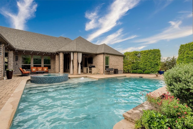 swimming pool with an outdoor living space with a fireplace and a patio