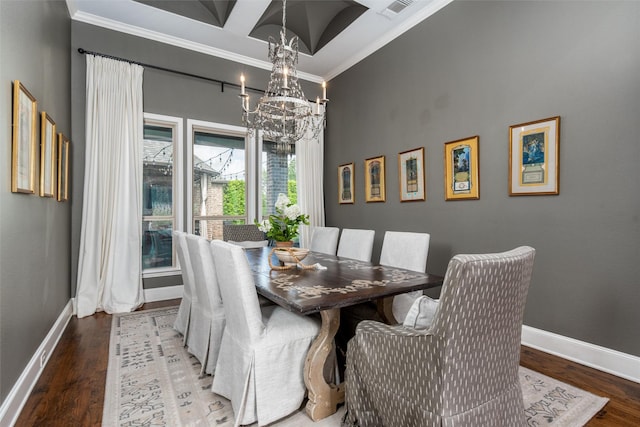 dining room featuring a chandelier, ornamental molding, baseboards, and wood finished floors