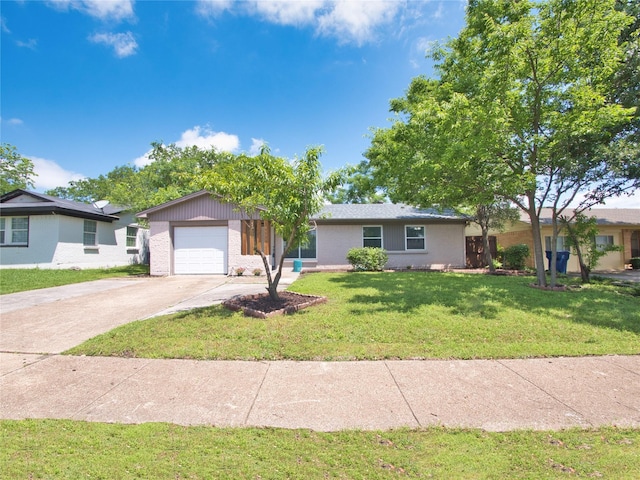ranch-style house featuring driveway, an attached garage, brick siding, and a front yard