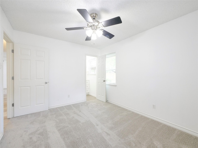 unfurnished bedroom featuring carpet floors, baseboards, and ceiling fan