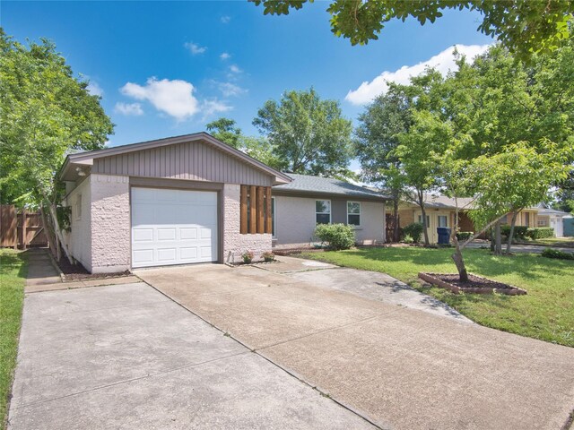 view of front of home with driveway, a garage, and brick siding