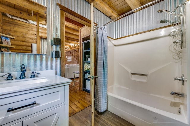 7386 Clint Ct, Athens, TX 75752 - full bathroom with rustic walls, hardwood / wood-style flooring, shower / bath combination with curtain, and vanity