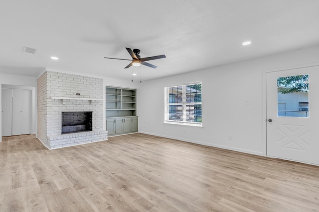 unfurnished living room featuring ceiling fan, light wood finished floors, baseboards, a fireplace, and recessed lighting