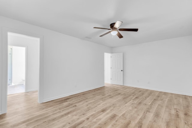 unfurnished room featuring ceiling fan, light wood finished floors, and baseboards