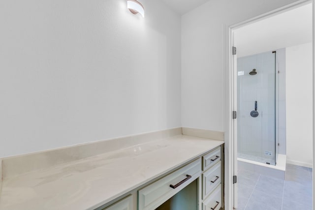 full bathroom with tiled shower and tile patterned flooring
