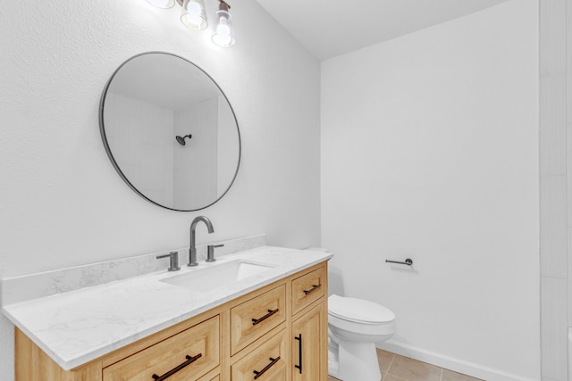 bathroom with toilet, tile patterned floors, vanity, and baseboards