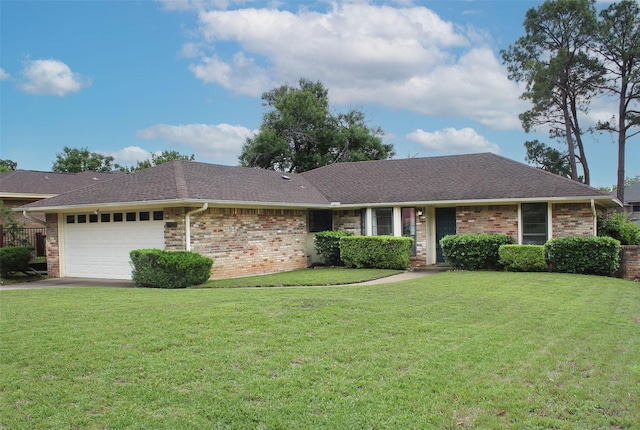 ranch-style house featuring brick siding, a garage, a front yard, and roof with shingles