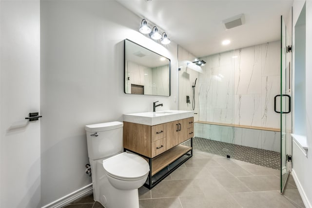 full bath featuring a marble finish shower, toilet, tile patterned flooring, vanity, and baseboards