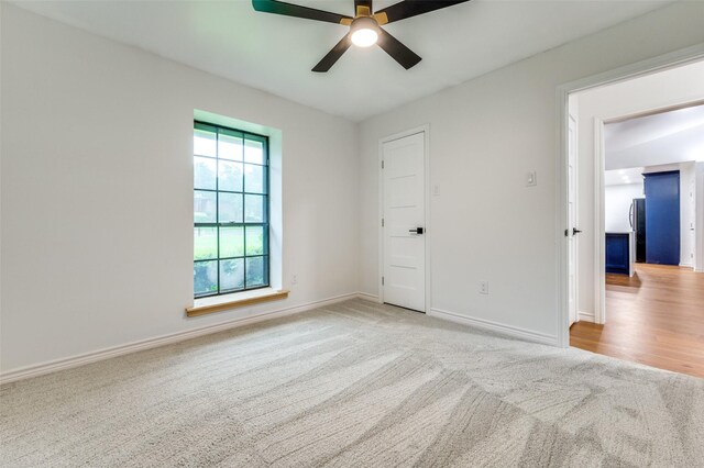 spare room with ceiling fan, carpet floors, and baseboards