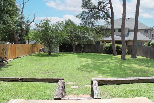 view of yard featuring an outbuilding and a storage shed