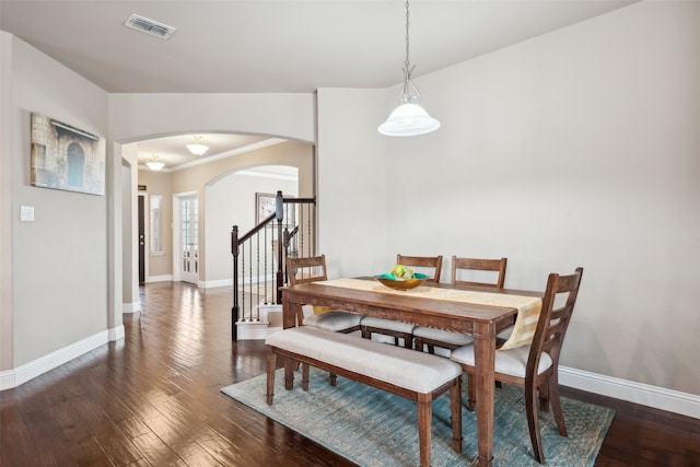 2612 Castle Creek Dr, Little Elm, TX 75068 - dining room featuring arched walkways, baseboards, wood finished floors, and crown molding