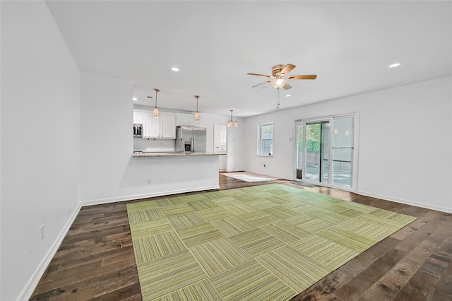 unfurnished living room featuring dark wood-style flooring, a ceiling fan, recessed lighting, and baseboards