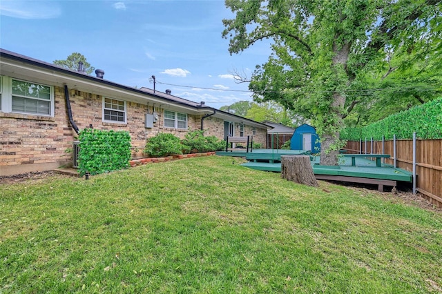 view of yard with a deck, a storage shed, and an outdoor structure