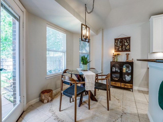 dining space with light tile patterned flooring, a chandelier, and baseboards