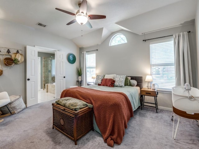 carpeted bedroom featuring vaulted ceiling, baseboards, a ceiling fan, and connected bathroom
