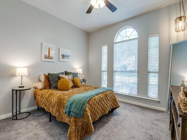 carpeted bedroom featuring baseboards and ceiling fan