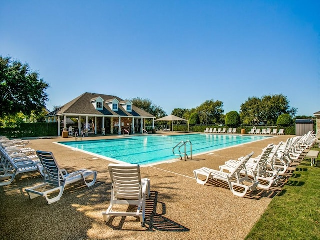 community pool featuring fence and a patio