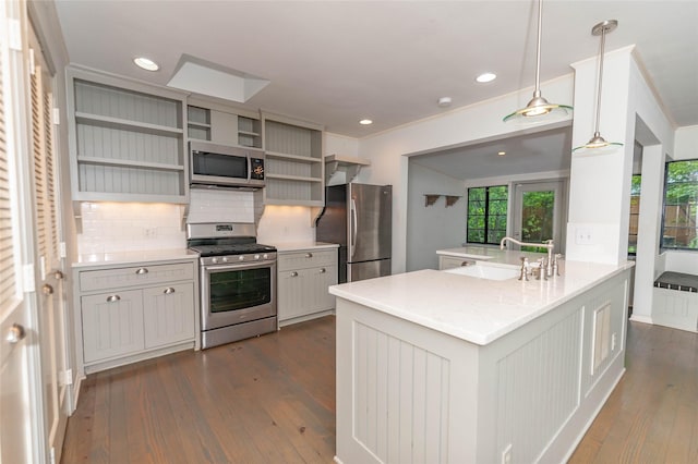 2850 Claudette Ave, Dallas, TX 75211 - kitchen featuring appliances with stainless steel finishes, a sink, tasteful backsplash, dark wood finished floors, and open shelves