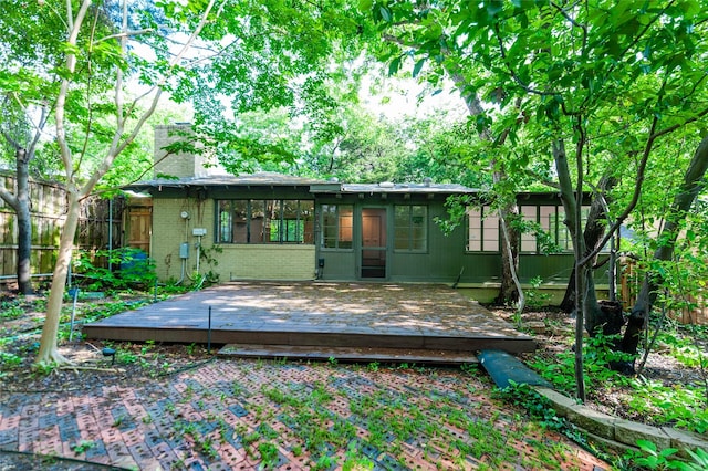 2850 Claudette Ave, Dallas, TX 75211 - back of property featuring a chimney, a deck, brick siding, and fence