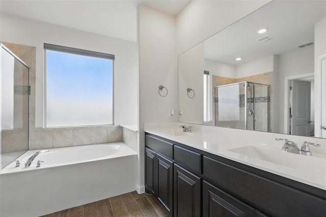 1206 Burlingame Dr, Cleburne, TX 76033 - bathroom featuring a shower stall, wood finished floors, a bath, and double vanity